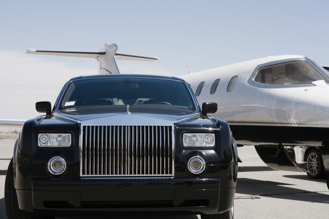 Rolls-Royce beside a private jet, from the Gio Jets client deck